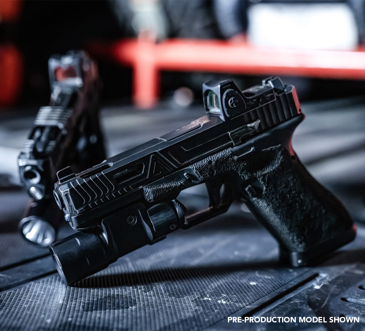 two pistols with weapon lights and optics