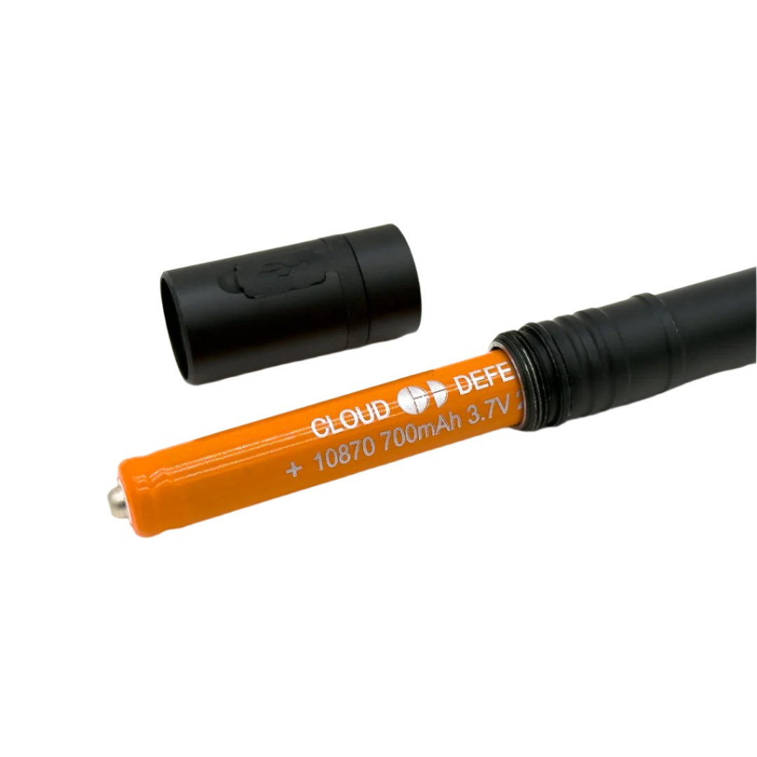 orange battery partially sticking out of flashlight with flashlight head set aside.