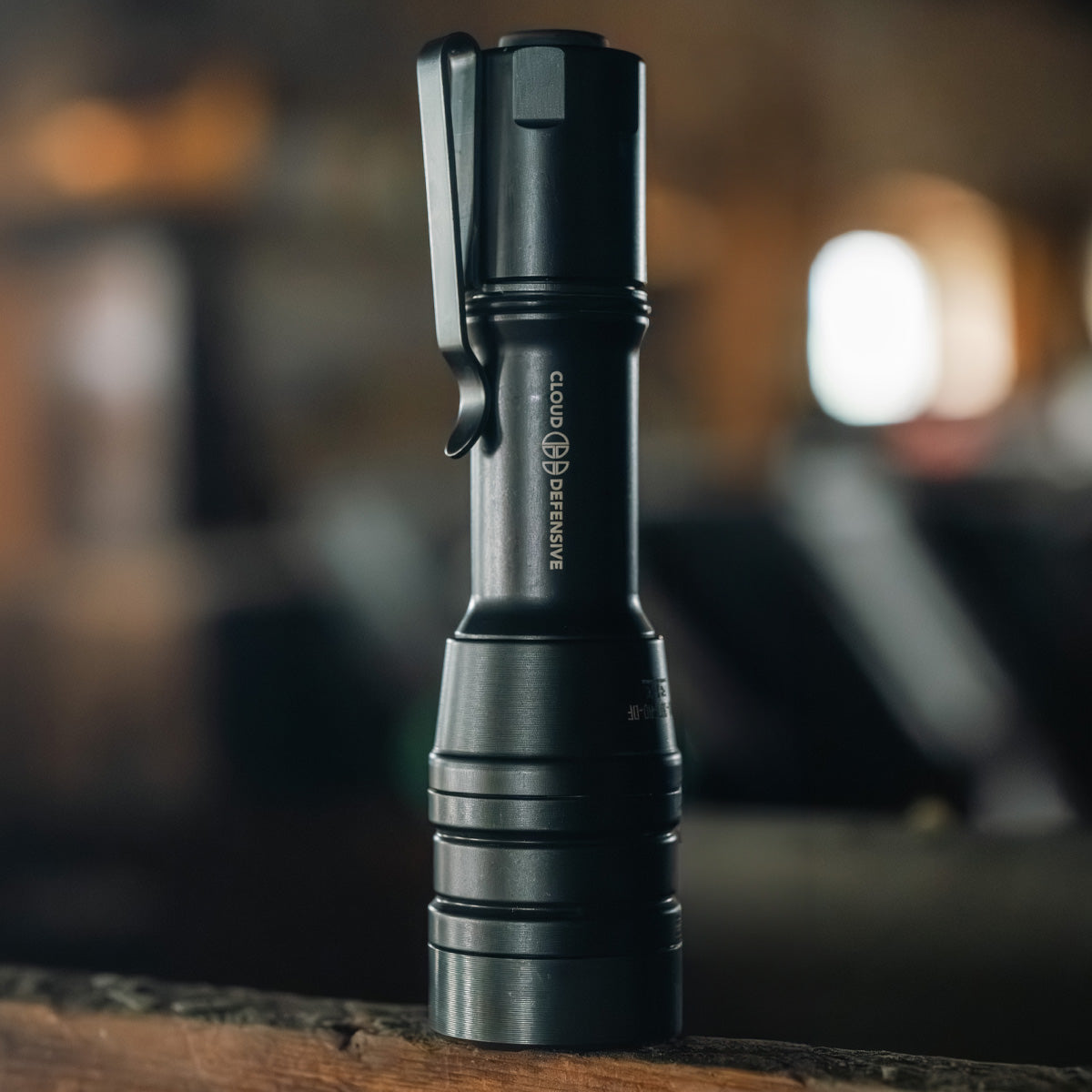 Close up of black MCH Duty flashlight on a wooden post