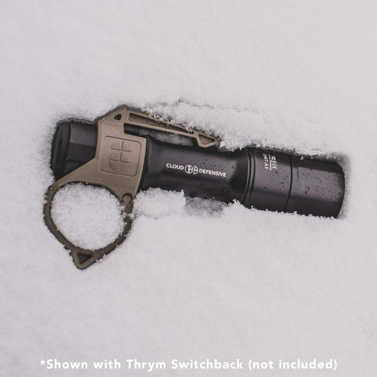 black MCH flashlight in the snow with tan Thyrm pocket clip